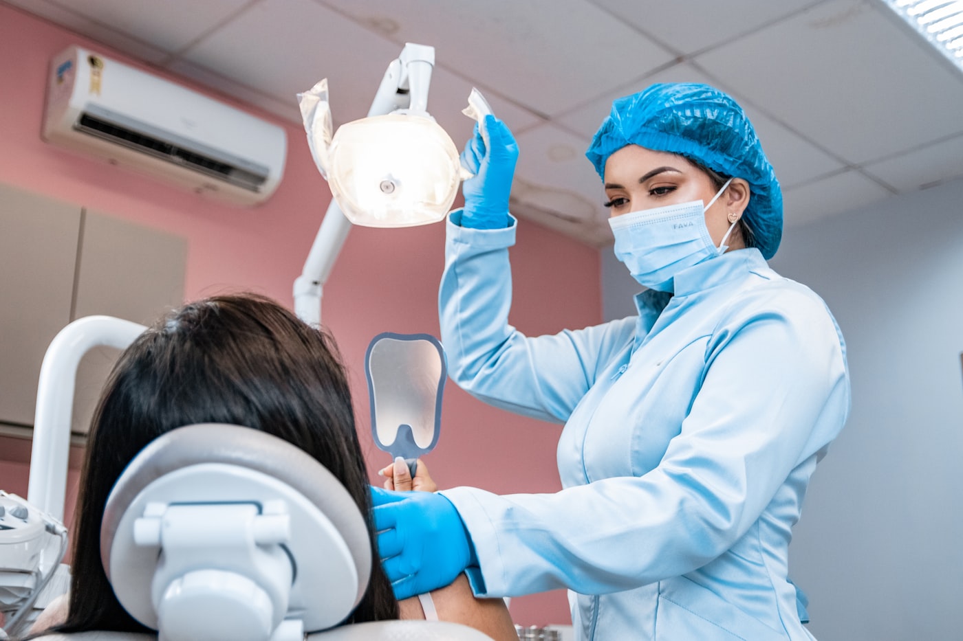 Dentist treating a patient chairside in a dental surgery