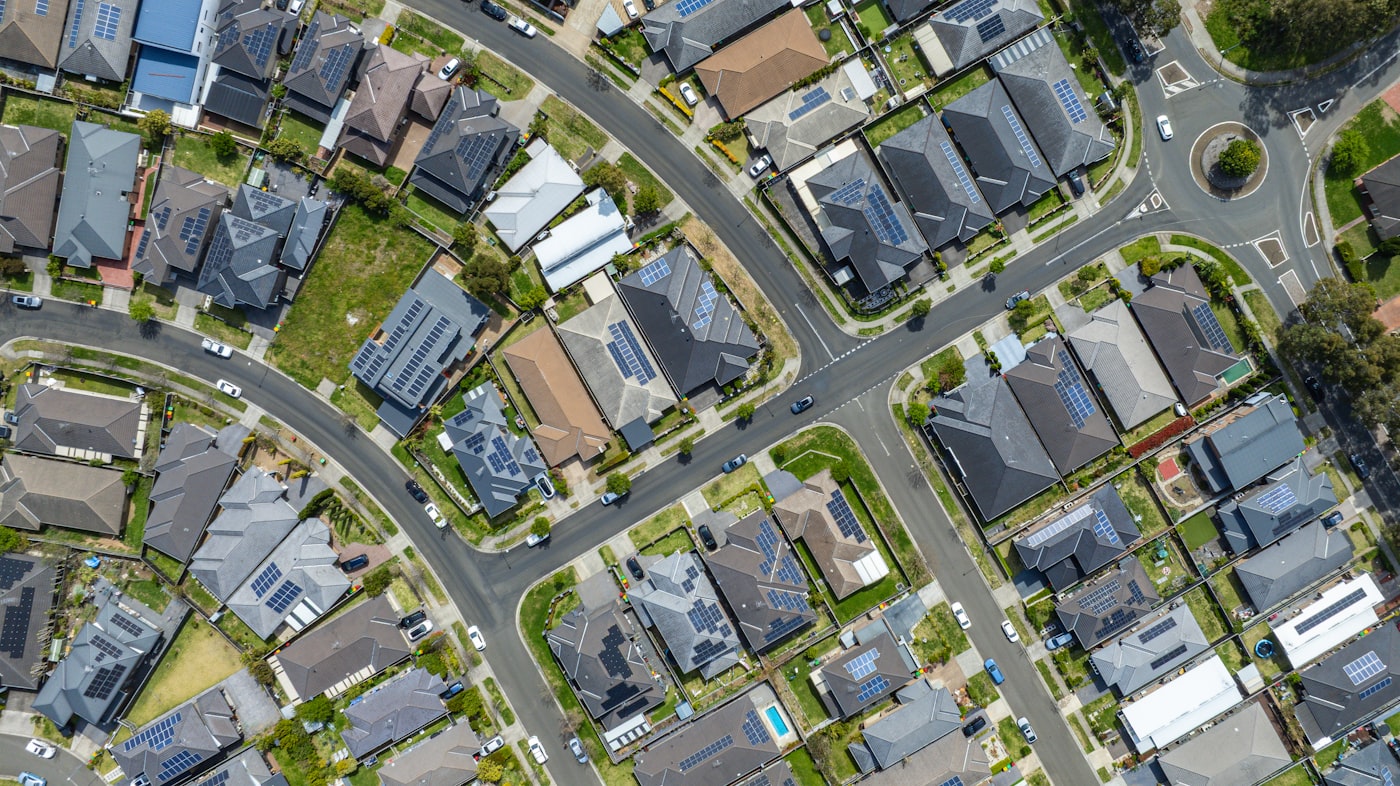 Aerial view of an Australian suburb with solar panels installed across the rooftops